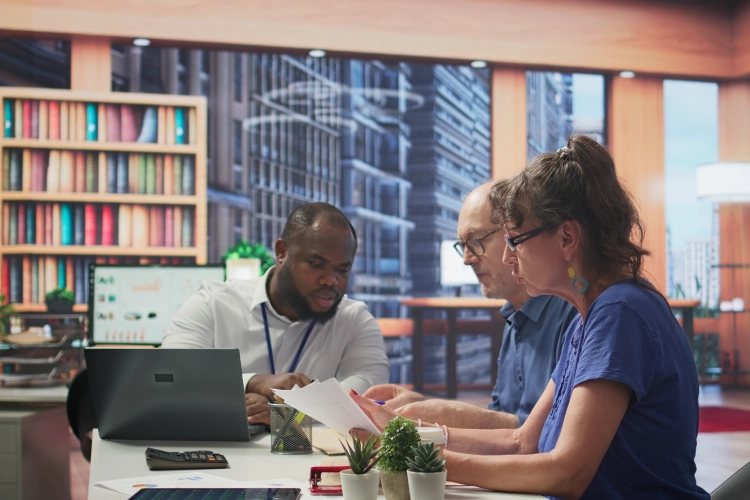 University staff collaborating on curriculum planning using digital management systems.